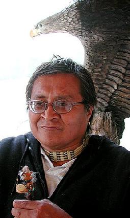 Norman Tom with one of his carvings